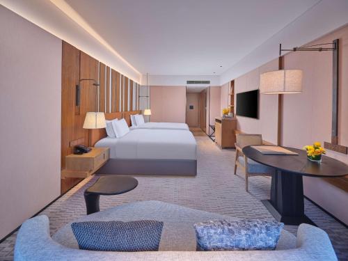 a hotel room with a bed and a couch at DoubleTree by Hilton Changbaishan Hot Spring in Antu