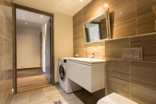 a bathroom with a washing machine and a sink at Cozy city apartment in Tallinn