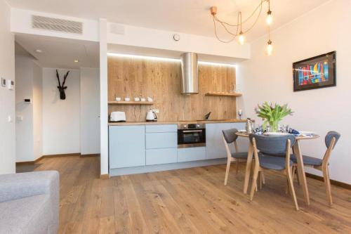 a kitchen and dining room with a table and chairs at Cozy city apartment in Tallinn