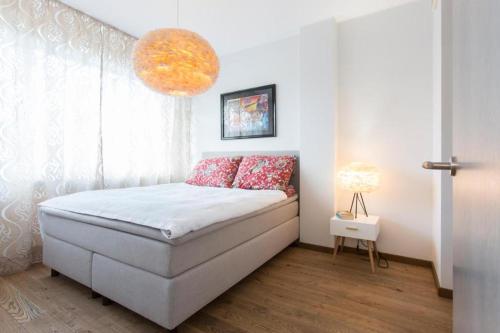 a bedroom with a bed with a large window at Cozy city apartment in Tallinn