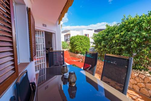 a balcony with a table and chairs on a patio at Apartment Chateau Morro 4 in Morro del Jable