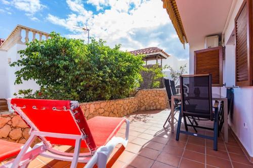 a patio with chairs and a table on a house at Apartment Chateau Morro 4 in Morro del Jable