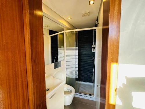 ein Bad mit einem WC und einer Glasdusche in der Unterkunft Amazing Flat Sao Bento in Porto