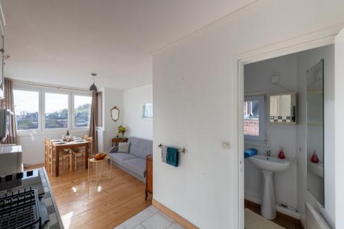 Una cocina y una sala de estar con un sofá y un fregadero. en Les Reflets de la Mer 5 - A moins d'1 km de la mer, en Le Tréport
