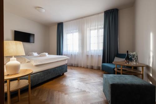 a hotel room with a bed and a window at Hotel Tanzberg Mikulov in Mikulov