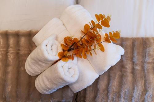 a towel with orange flowers on top of a bed at Apartamento Larrazu Agroturismo Baztán in Arráyoz