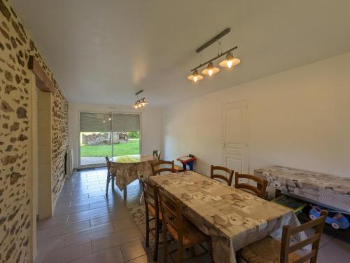 une salle à manger avec tables et chaises et une fenêtre dans l'établissement Gîte familial au calme avec grand jardin, balnéo et loisirs nautiques à proximité - FR-1-591-134, à Pouligny-Notre-Dame