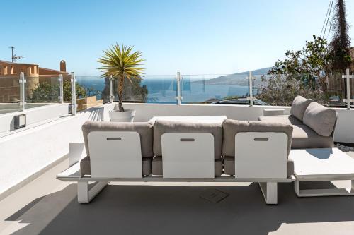a couch and chairs sitting on top of a roof at Chalet con piscina en Tabaiba by Alterhome in Santa Cruz de Tenerife