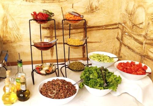 a table topped with bowls of different types of food at Autopapa in Rustavi