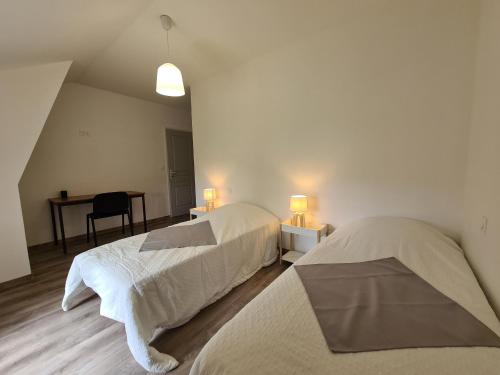 a bedroom with two beds and a desk and a table at Gîte Montierchaume, 4 pièces, 6 personnes - FR-1-591-359 in Montierchaume