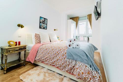 a bedroom with a bed with two stuffed animals on it at Modern 3 bedroom Flat in Lisbon in Lisbon