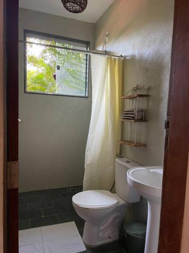 a bathroom with a toilet and a sink at Casa Bacuri in Porto Seguro
