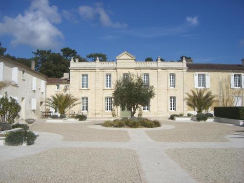 un grand bâtiment bien exposé avec des arbres devant lui dans l'établissement Domaine de Saint Palais, à Saint-Palais-sur-Mer