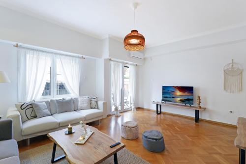 a living room with a couch and a table at Central Kolonaki flat B - Greecing in Athens