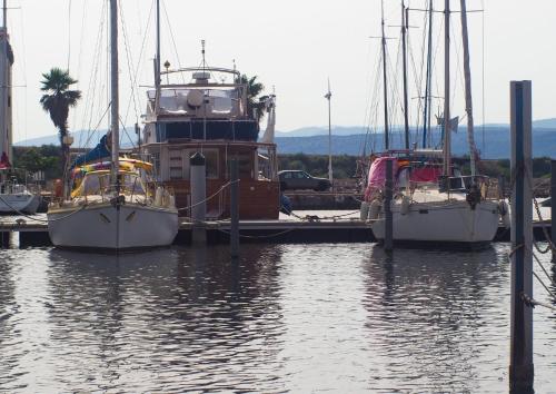 three boats are docked at a dock in the water at Petit coin de paradis à Port-Leucate in Port Leucate
