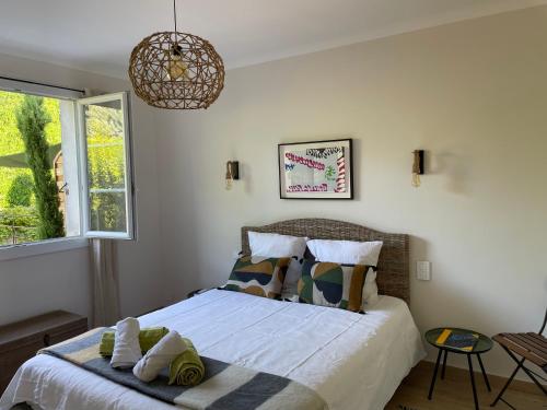 een slaapkamer met een bed met handdoeken erop bij La Petite Rive - Les Oliviers in Velleron
