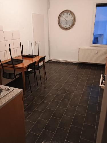 una stanza con due tavoli e un orologio sul muro di Monteurzimmer Pavan H1 - KEINE FERIENWOHNUNG a Gevelsberg