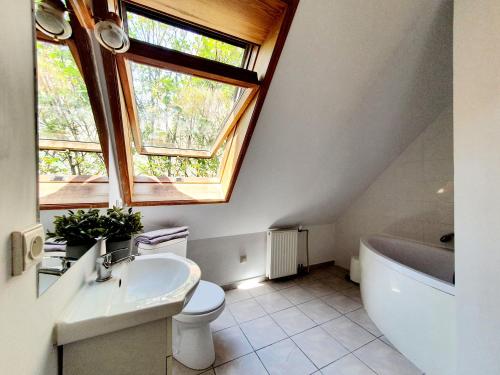 a bathroom with a sink and a toilet and a window at Tanie pokoje w centrum in Sopot