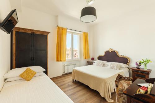 a bedroom with two beds and a window at Guest House Maison 6 in Lido di Ostia