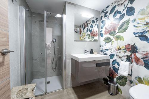 a bathroom with a shower and a sink at Hostal Boutique Aurora in Nerja