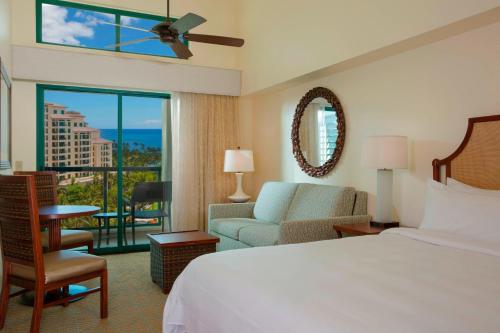 a hotel room with a bed and a view of the ocean at Marriott's Ko Olina Beach Club in Kapolei