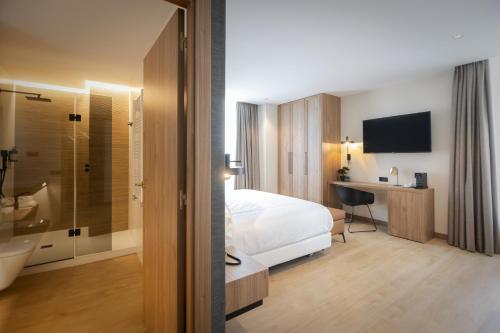 een hotelkamer met een bed en een badkamer bij Hotel & Spa Convento San Francisco in Soria