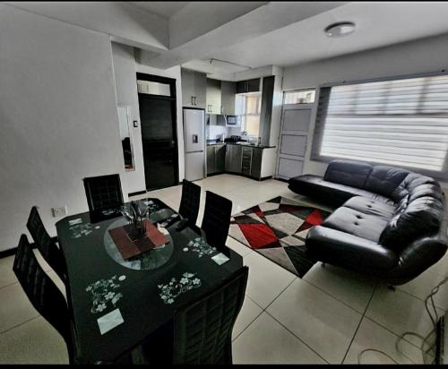 a living room with a table and a couch at Beachurst Apartment in Durban