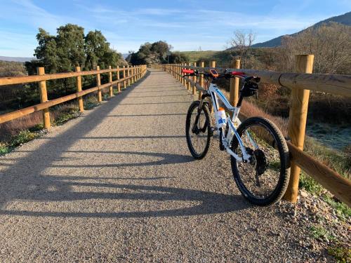 a bike parked next to a fence on a road at Las Musas, Casa Rural in Hervás