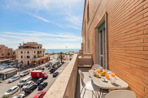 a balcony with a table and a view of a city at Guest House Maison 6 in Lido di Ostia