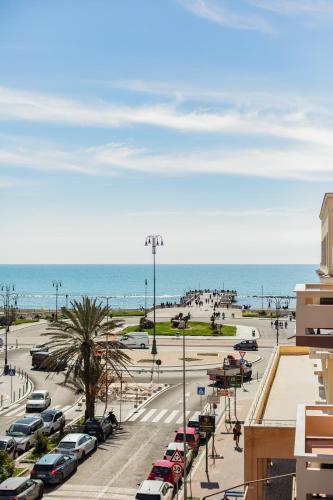 a parking lot next to the beach with cars parked at Guest House Maison 6 in Lido di Ostia