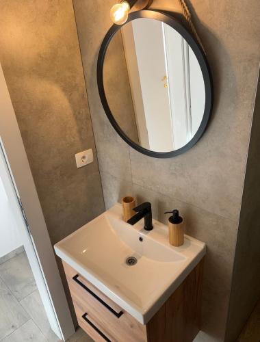 a bathroom with a sink and a mirror at Luxury house Ivan with 4 bedrooms in Divojevići