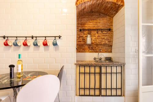 a kitchen with a counter and a sink and a table at LD Apartments Alfama in Lisbon