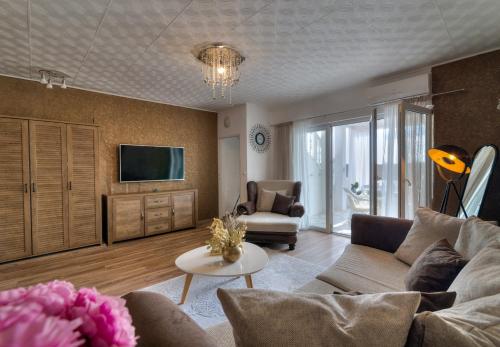 a living room with a couch and a tv at Casa Memory in Crikvenica