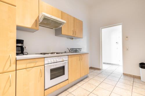 a kitchen with wooden cabinets and a stove at Getreide T13 in Vienna