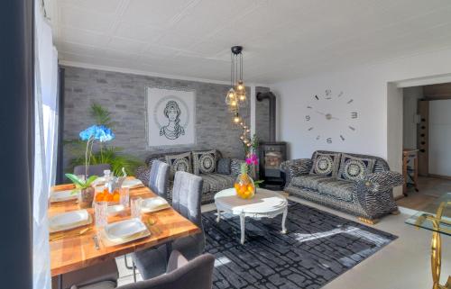 a living room with a table and a couch at Casa Memory in Crikvenica