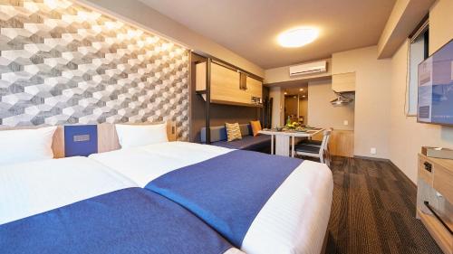 a hotel room with a large bed and a table at MONday Apart Asakusabashi Akihabara in Tokyo
