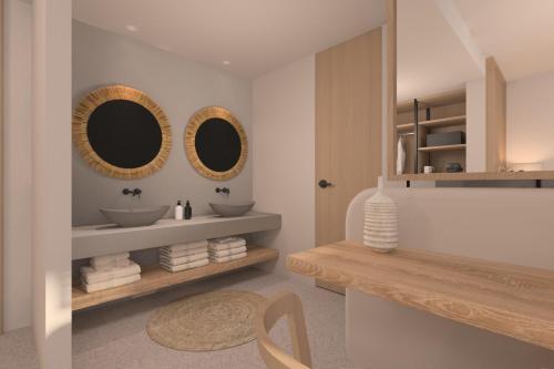ein Badezimmer mit zwei Waschbecken und zwei Spiegeln in der Unterkunft Ventale Island Breeze Resort in Georgioupoli