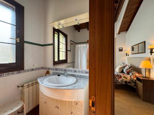 a bathroom with a sink and a mirror at Casa Rio Cubas in Cubas