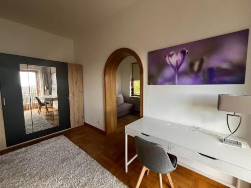 a room with a white desk and a mirror at Almschlössl in Baden