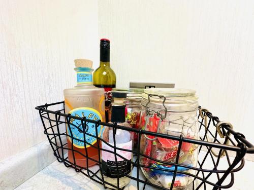 a basket with bottles of wine and jars at Ocean Breeze in Filey