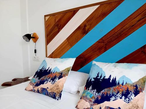 a bed with two pillows on it with mountains at Villa Stefi in Playa Blanca