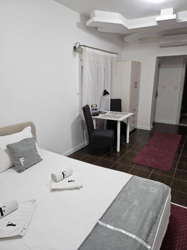 a bedroom with a bed with a desk and a chair at ForS Konak Apartments in Belgrade