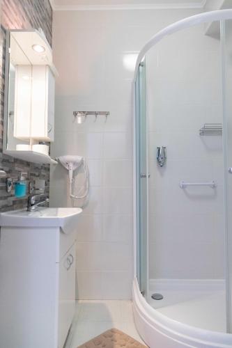 a bathroom with a shower and a sink at Farkas Villa in Mórahalom