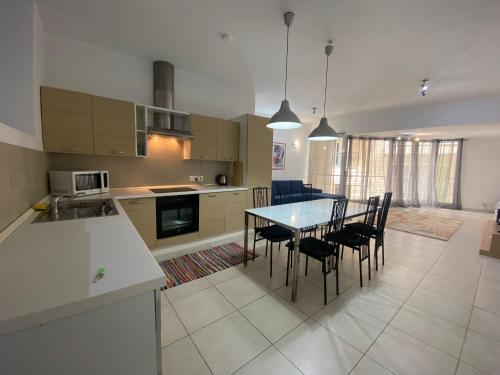 a kitchen and dining room with a table and chairs at Sliema 2bed with Backyard in Sliema