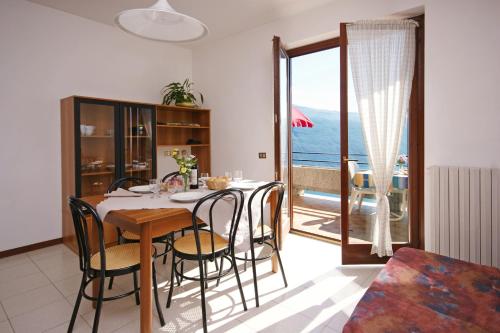 a dining room with a table and a view of the ocean at Hotel Residence La Rotonda in Tignale