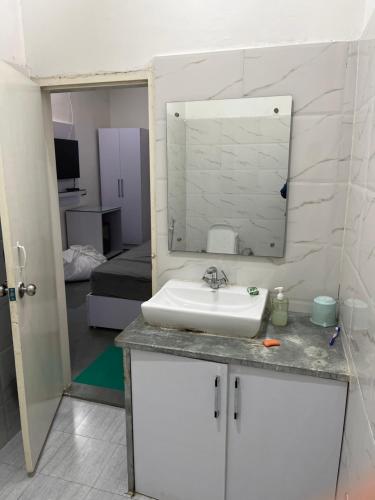 a bathroom with a sink and a mirror at Zoravar Farms in Sohna