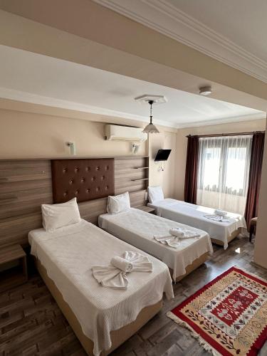 a hotel room with two beds in a room at Akay Hotel in Selcuk