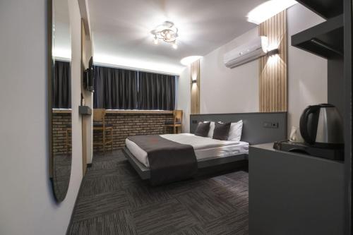 a hotel room with a bed and a television at DEWY HOTEL in İzmir