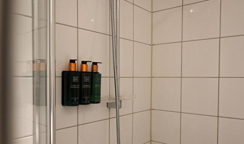 a bathroom with a shower with bottles on a shelf at Clarion Hotel Oslo Airport in Gardermoen