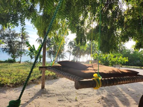a hammock hanging from a tree in a park at Sunset Getaway- Villa Makuti in Kizimkazi